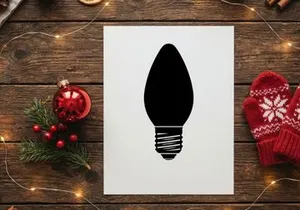 Black silhouette of a Christmas light bulb isolated on a white background