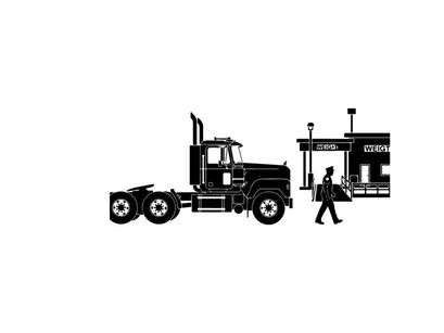 Silhouette of a man walking next to a semi truck and building