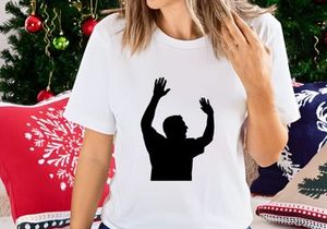 A silhouette of a man with his hands raised up in the air