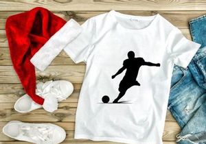 Soccer player kicking a ball in mid action silhouette