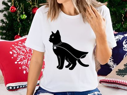 Black cat in cape and shamrock charm
