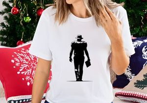 Silhouette of a man walking away in a hat with a briefcase