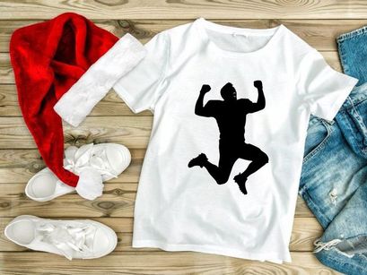 A silhouette of a person jumping up in the air with fists raised in triumph