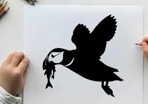 Silhouette of a puffin flying with a fish in its beak outdoors