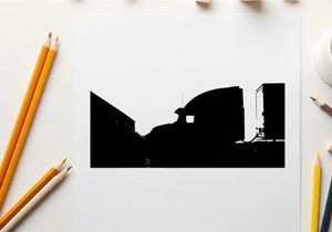 Silhouette of a semi truck driving down a road at sunset