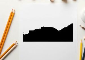 Silhouette of a pickup truck in front of a mountain range silhouette