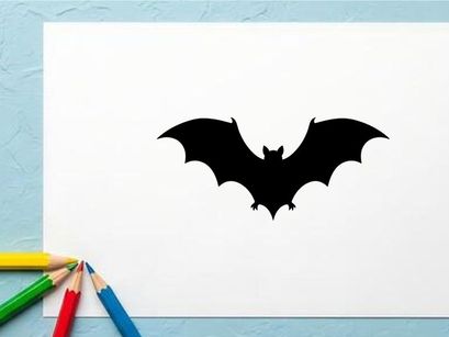 Silhouette of a Bat Flying with Spread Wings in Dark Night Scene
