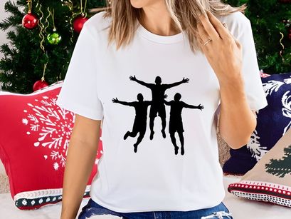 Three silhouetted friends jumping together in joy and freedom