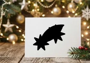 Black silhouette of a Christmas shooting star icon isolated on a white background