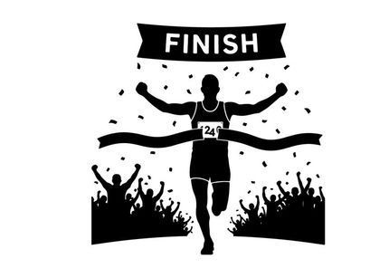 Silhouette of a runner crossing the finish line with cheering crowd
