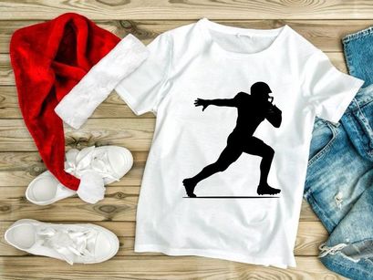 American football player running with ball in hand silhouette