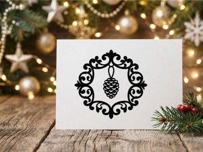 Black silhouette of a pine cone inside an ornate decorative circular frame for Christmas