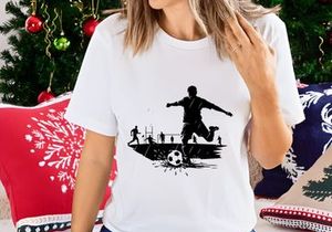 Soccer player kicking ball in rain with teammates in background on field