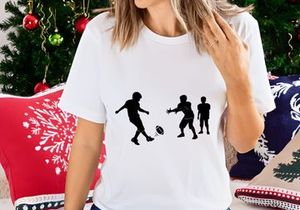 Silhouette of three boys playing rugby with a ball on a field