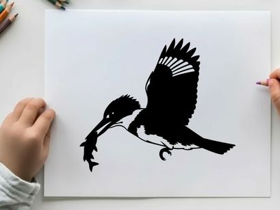 Silhouette of a kingfisher in flight with fish