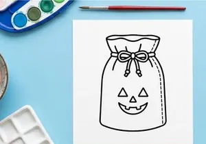 Halloween trick or treat candy bag with jack-o-lantern face. Festive paper sack for collecting sweets and spooky party favors.