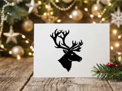 Black silhouette of a deer head with large antlers isolated on a white background.