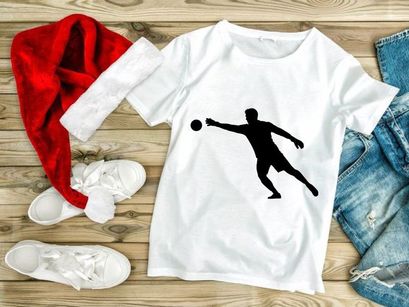 A silhouette of a man playing handball in dynamic motion with a ball