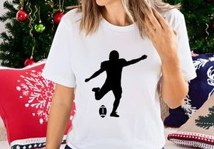 Rugby player kicking a rugby ball in mid action silhouette