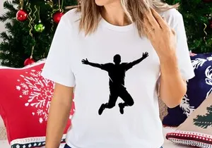 A silhouette of a man jumping in the air with arms outstretched and legs bent