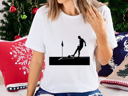 Silhouette of a soccer player kicking a ball near a corner flag on a field