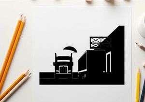 Truck silhouette parked beside a warehouse at sunset