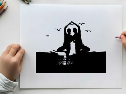 Silhouette of two people doing yoga on the beach at sunset