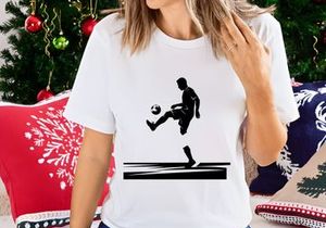 Silhouette of a soccer player kicking a ball in mid action