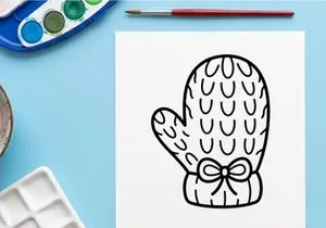 Hand-drawn Halloween mitten with ghost pattern and ribbon bow. Spooky knitted glove illustration for festive fall and winter designs.