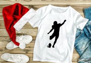 Silhouette of a soccer player kicking a ball in mid action