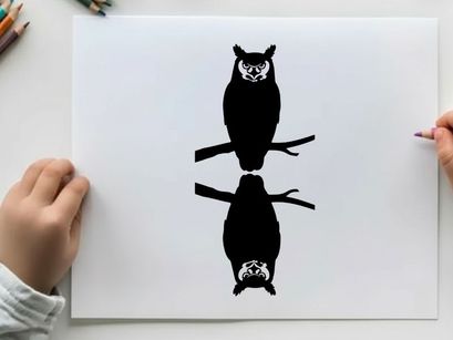 Silhouette of two owls perched on branches facing opposite directions