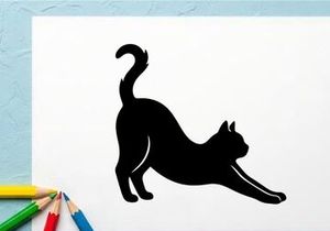 Silhouette of a Stretching Cat in a Playful Pose