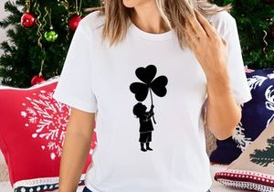 Child holding heart balloons joyful outdoor celebration silhouette