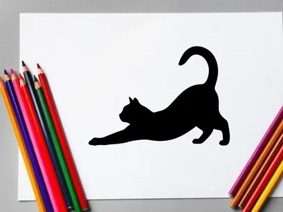Silhouette of a playful black cat stretching on a white background