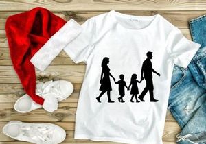 Happy family walking together holding hands silhouette outdoor