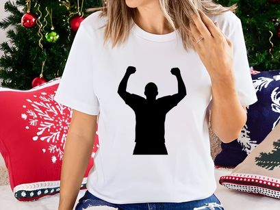 A triumphant man standing with arms raised in victory and celebration