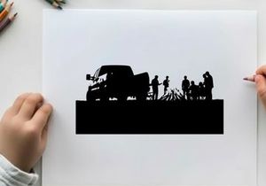Silhouette of people gathered around campfire beside a truck