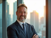 Headshot of a businessman in a suit.