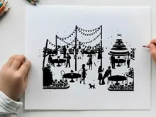 Silhouette of people at an outdoor party with cake