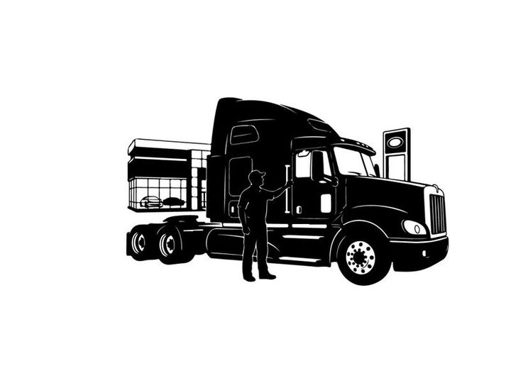 Silhouette of a man standing beside a large semi truck
