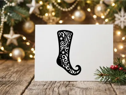 Black Christmas stocking silhouette with intricate floral filigree and star patterns.
