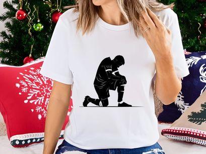 Soccer player kneeling on one knee in contemplation or injury assessment