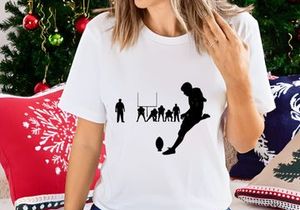 Rugby player kicking ball in action on field with team