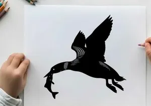 Silhouette of a bird in flight with prey