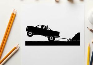 Silhouette of a pickup truck towing a trailer up a steep incline