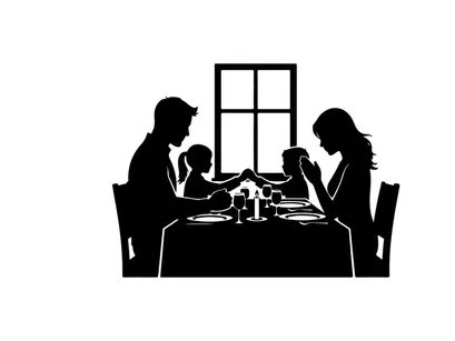 Family dinner in silhouette by the window