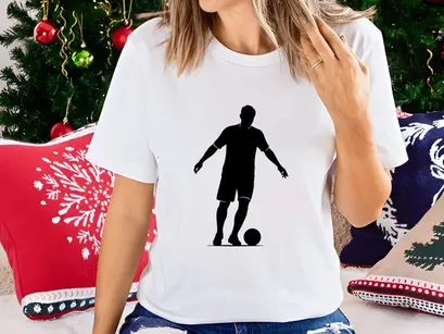 Silhouette of a soccer player kicking a ball in action