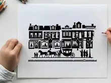 Silhouette of a horse drawn carriage in front of buildings