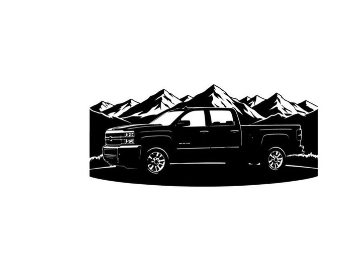 Silhouette of a pickup truck in front of mountains