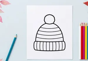 Topi rajut musim dingin buatan tangan dengan tepi terlipat terisolasi di latar belakang putih untuk desain liburan
